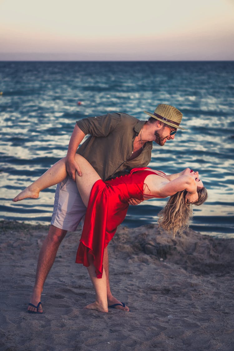 A Couple Dancing On The Beach Together