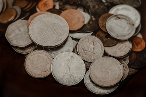 A Bunch of Silver Coins in Close-up Photography