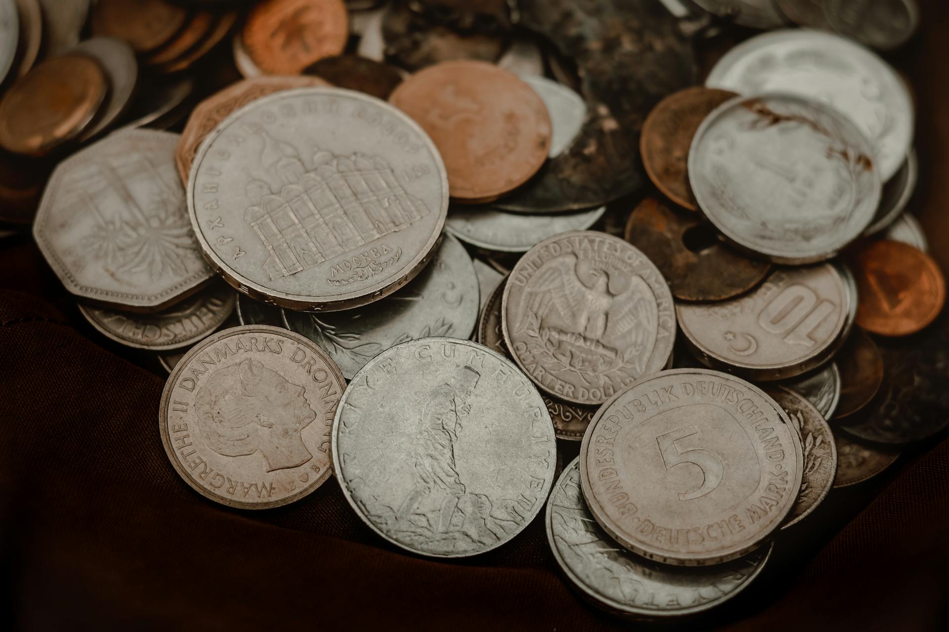 Collection of various vintage coins showcasing global currency diversity.