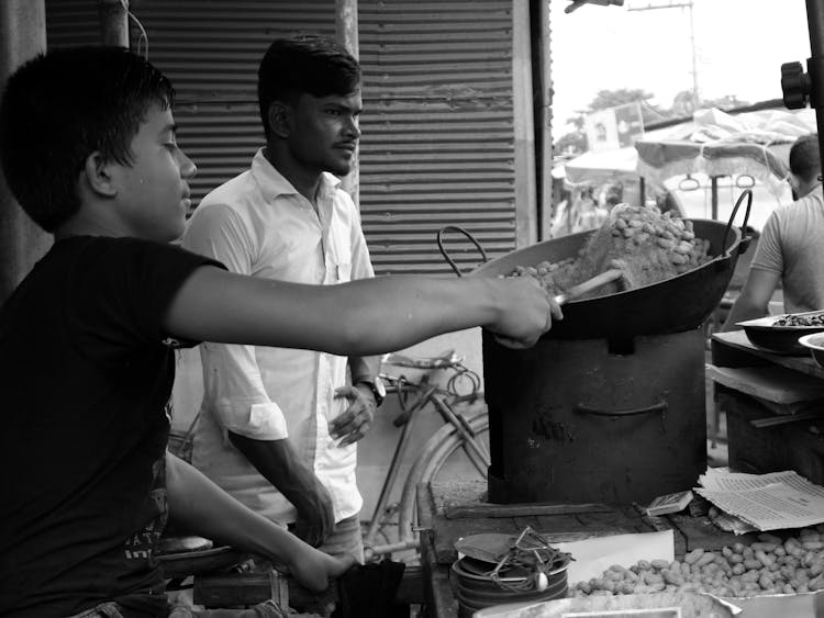 Boy In Black Shirt Cooking