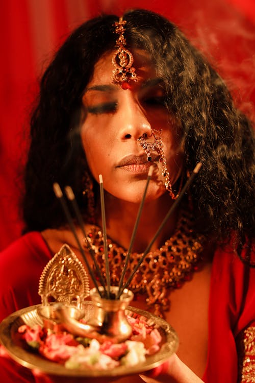 Woman Holding Plate with Incenses