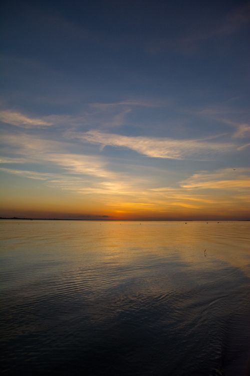 Free Calm and tranquil sunset over the ocean in Sales, Brazil, reflecting a picturesque sky. Stock Photo