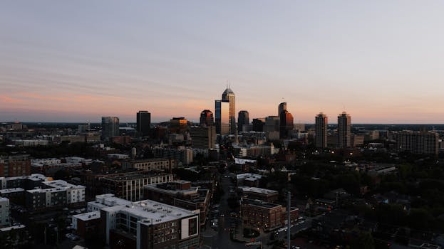 A stunning aerial view of Indianapolis skyline during sunset, showcasing urban architecture.
