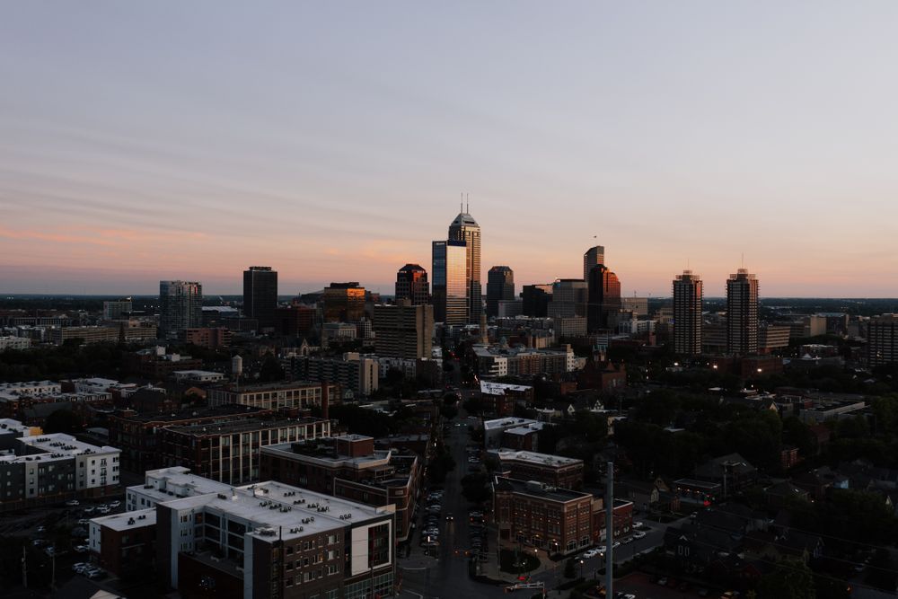 A stunning aerial view of Indianapolis skyline during sunset, showcasing urban architecture.