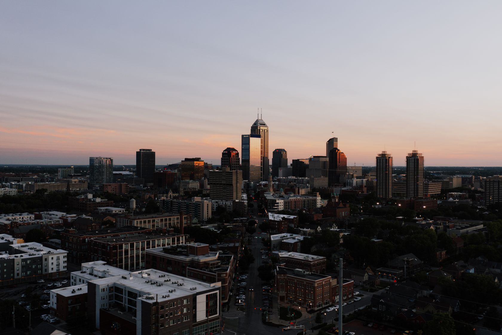 A stunning aerial view of Indianapolis skyline during sunset, showcasing urban architecture.