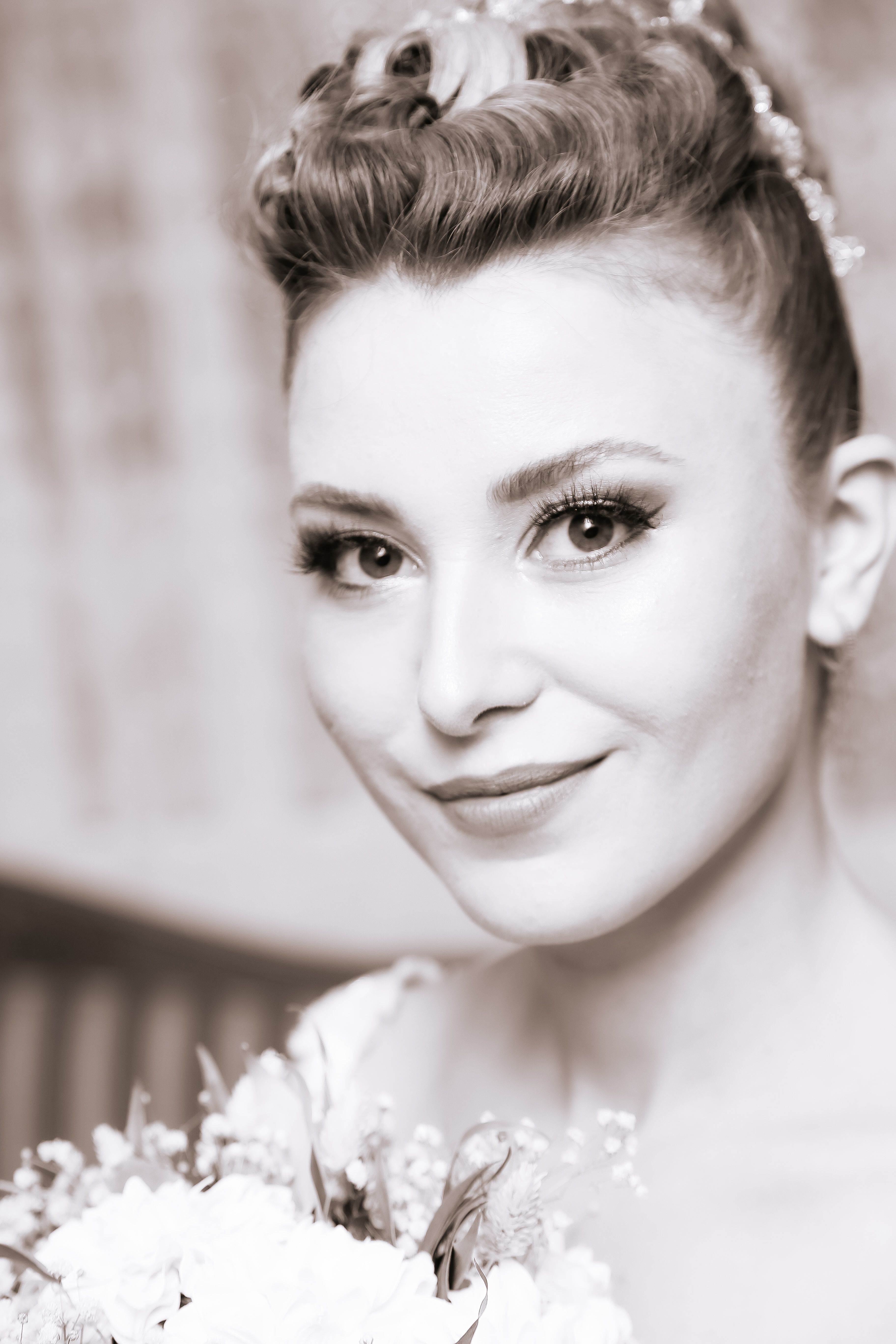 Charming bridal portrait showcasing elegance and grace in black and white.
