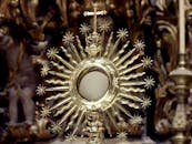 Golden monstrance against blurred church interior