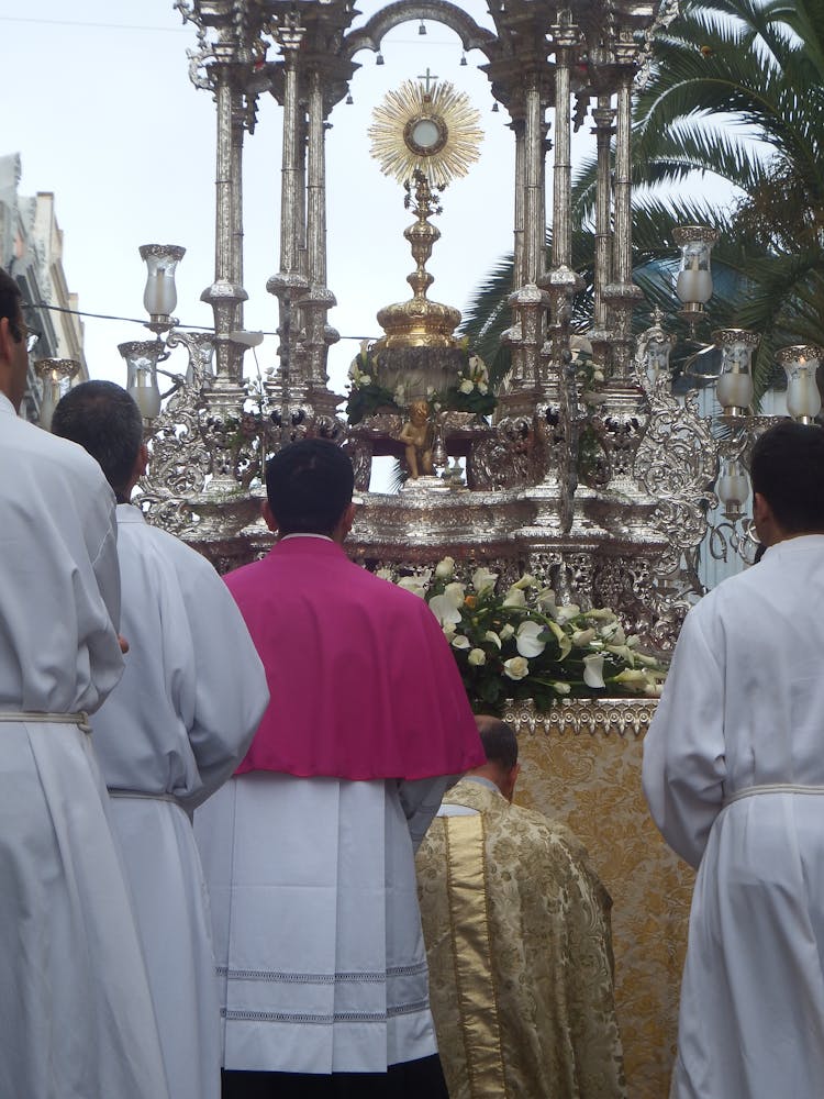 Catholic Priests During Religious Procession With Monstrance