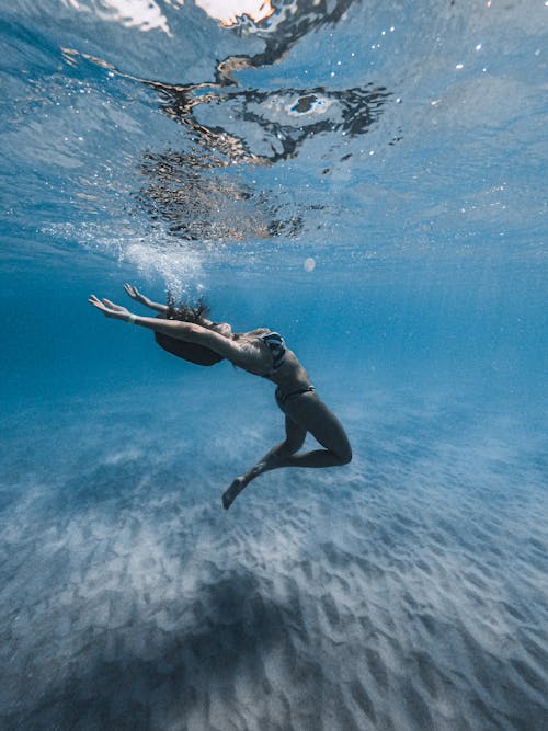 Free Woman in Black Bikini Swimming Underwater Stock Photo