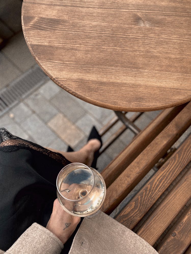 Overhead Shot Of A Person Holding A Glass Of Champagne