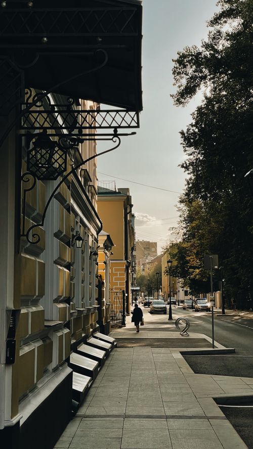 Free A calm city street in Moscow, Russia, lined with historic buildings and autumn trees. Stock Photo