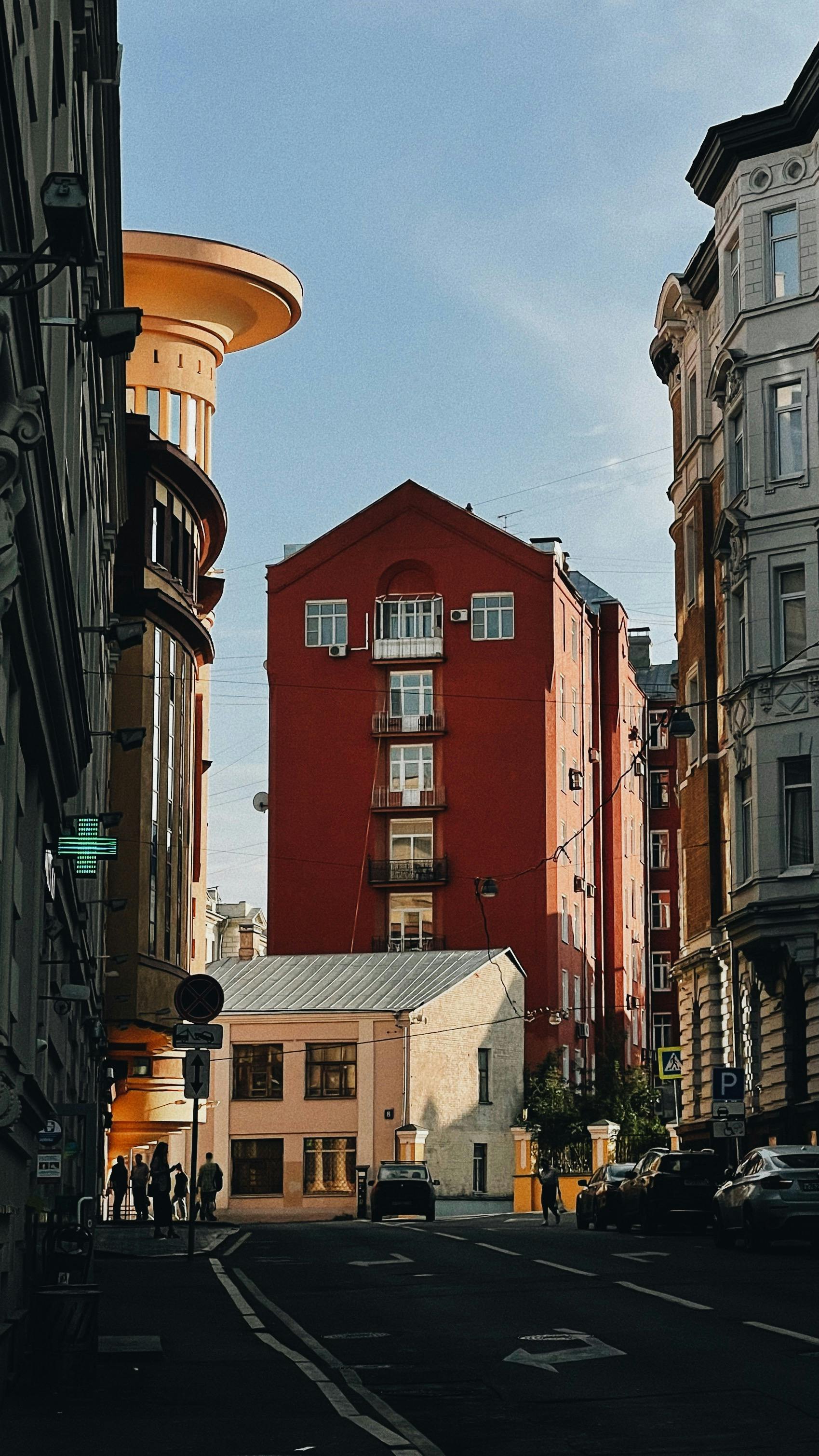 Explore urban architecture in Moskva, Russia with this charming street view featuring colorful buildings.