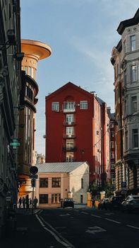 Explore urban architecture in Moskva, Russia with this charming street view featuring colorful buildings.