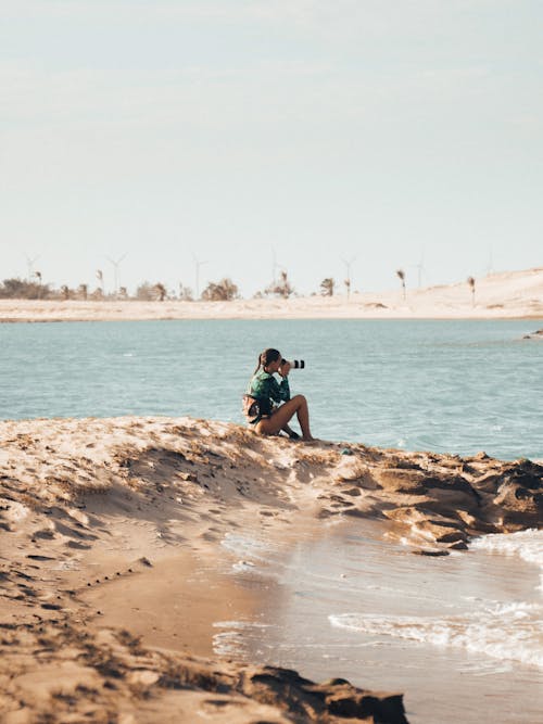 A Woman Taking a Photo at the Beach