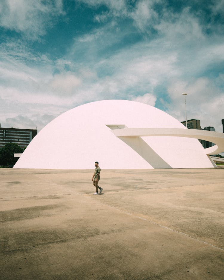 Man Walking Near Modern Architecture Building