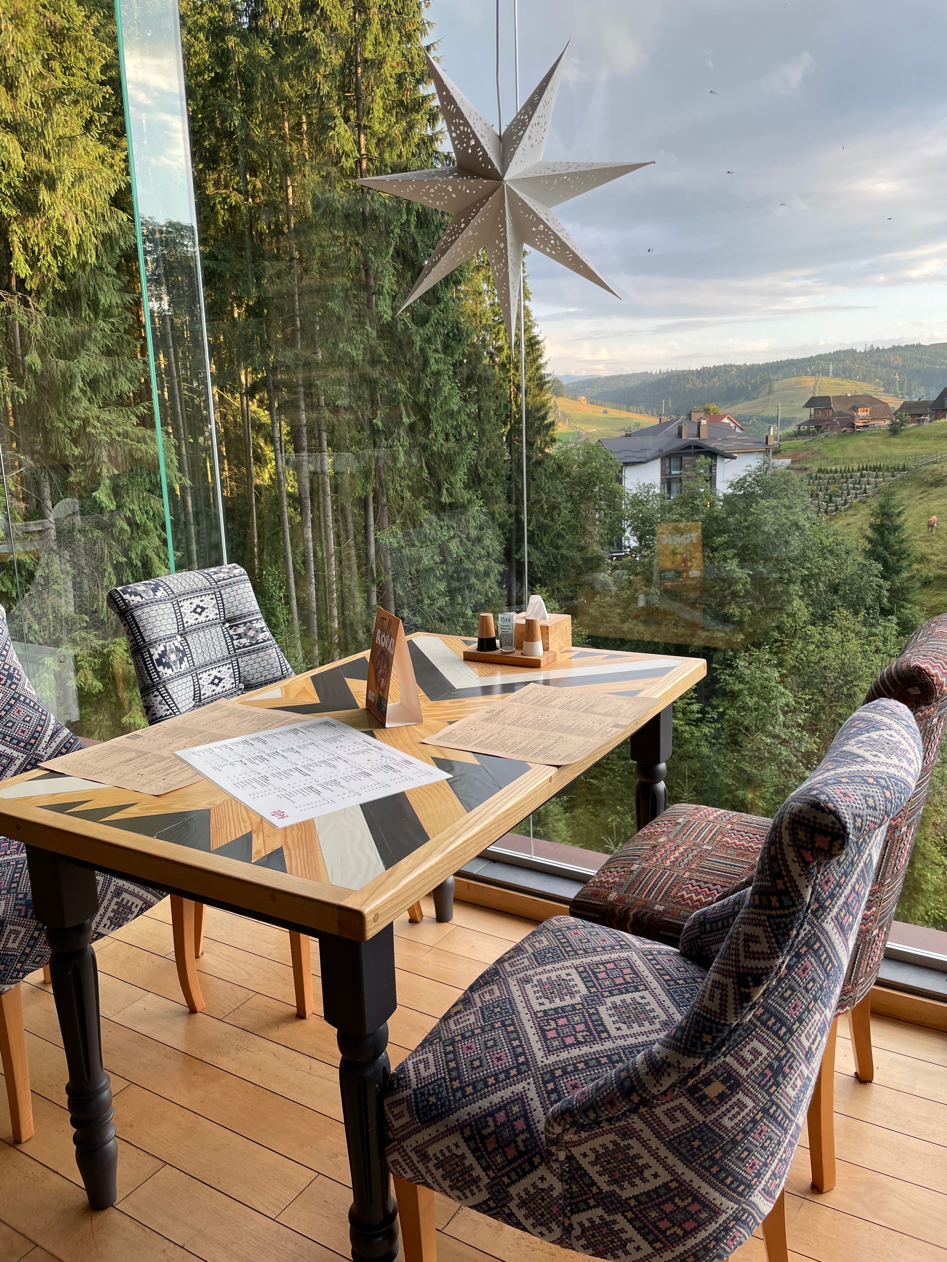 Table in Restaurant Overlooking Rural Mountain Scenery · Free Stock Photo