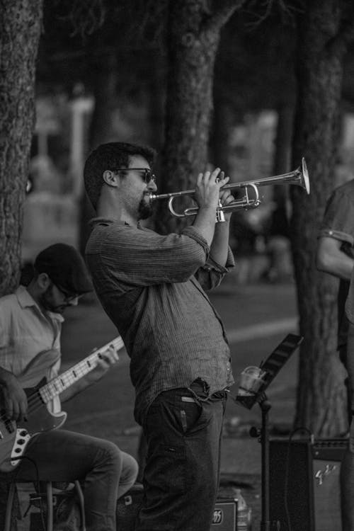Free Man Playing Trumpet in Grayscale Photography Stock Photo