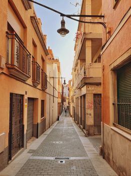 Scenic view of a narrow residential street with charming old buildings in a European town.