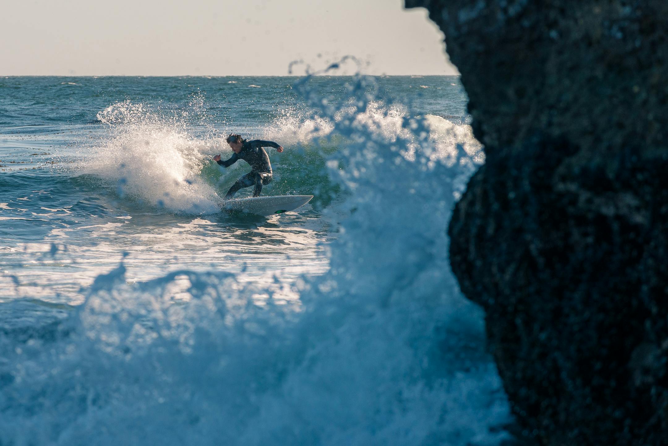 Thrilling shot of a surfer expertly navigating powerful ocean waves. Perfect for adventure and sports themes.
