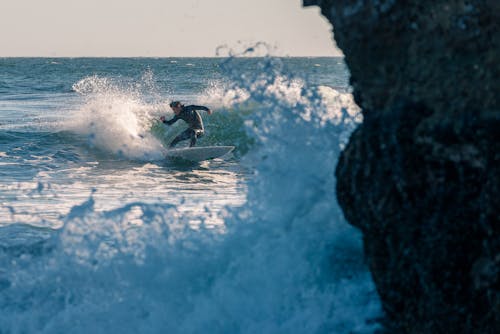 Man Surfing on Body of Water