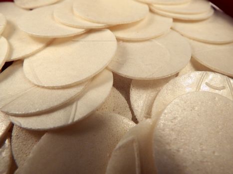 Pile of thin white circles of Sacramental bread