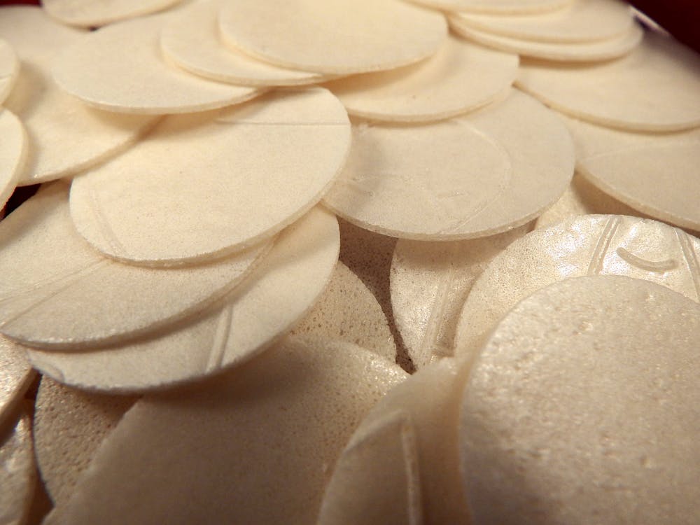 Pile of thin white circles of Sacramental bread