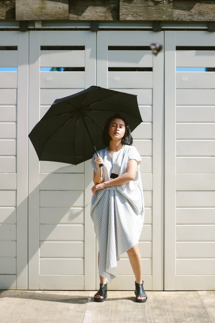 Woman In White And Black Dress Holding Umbrella