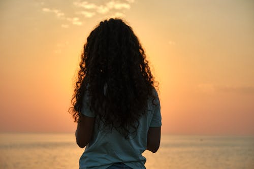 Free Back View of a Woman During the Golden Hour  Stock Photo