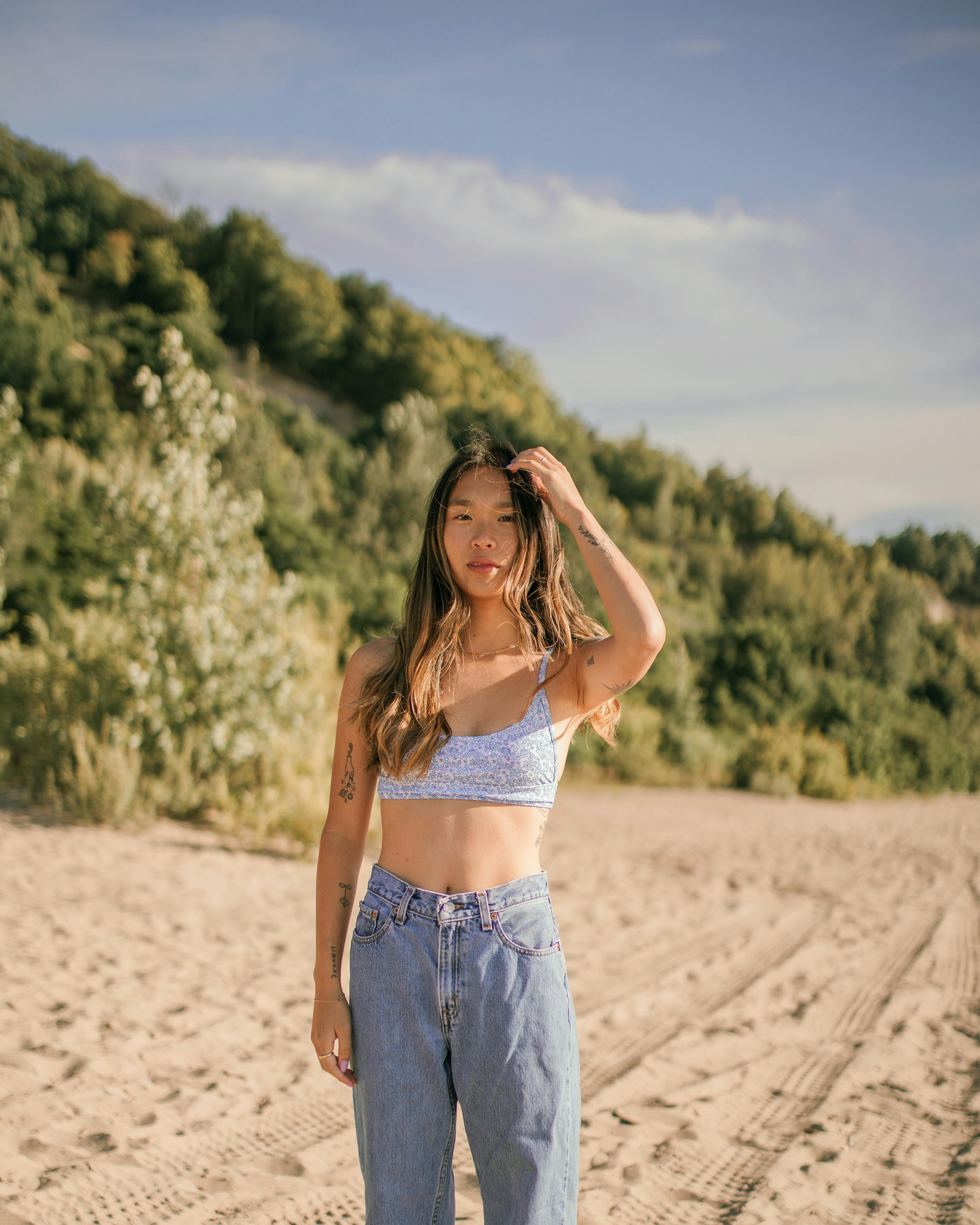 A Woman Wearing Crop Top and Denim Jeans · Free Stock Photo