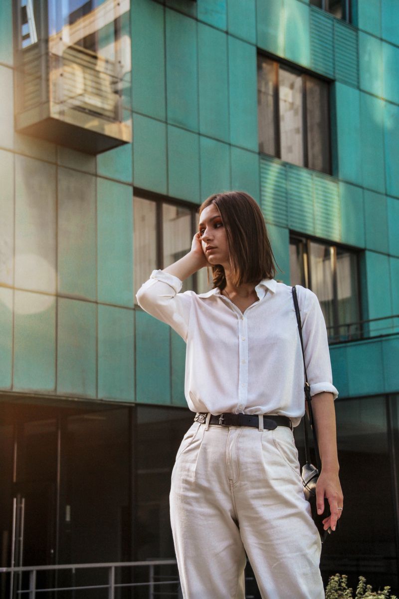 woman wearing white shirt and pleated trousers office