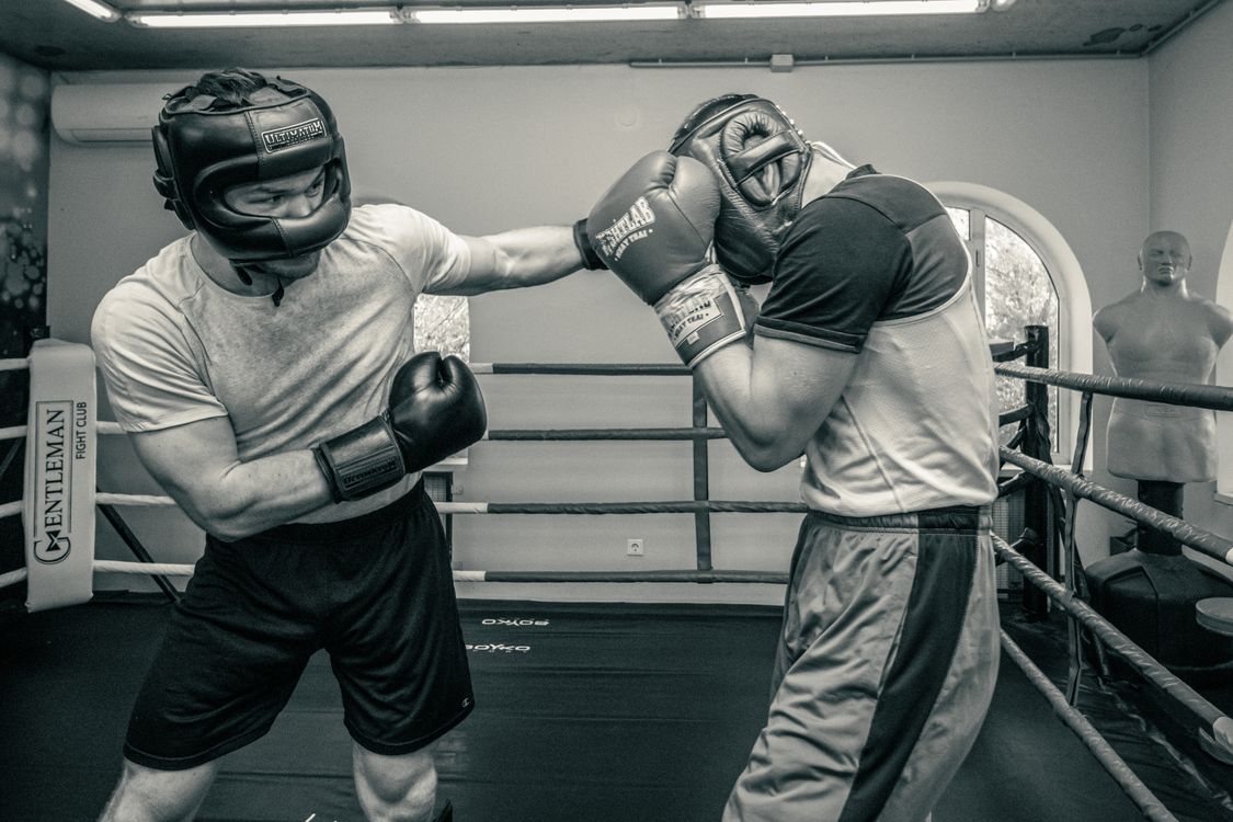 Two Persons Fighting Inside the Boxing Ring · Free Stock Photo