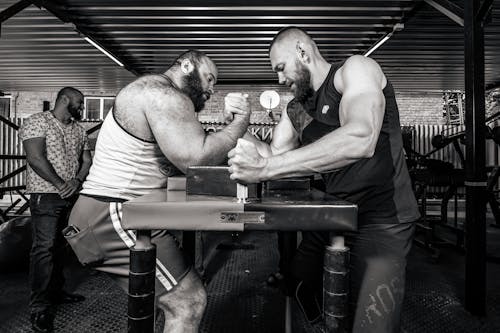 Strong Men Doing an Arm Wrestling Match