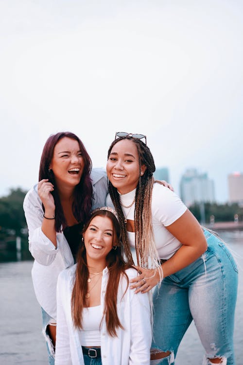 A Group of Friends Wearing White Tops while Smiling