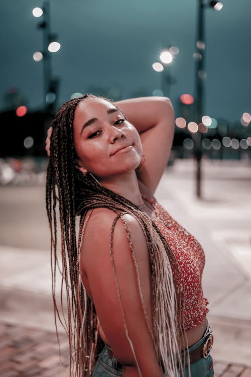 A Woman Smiling with Her Long Braided Hair