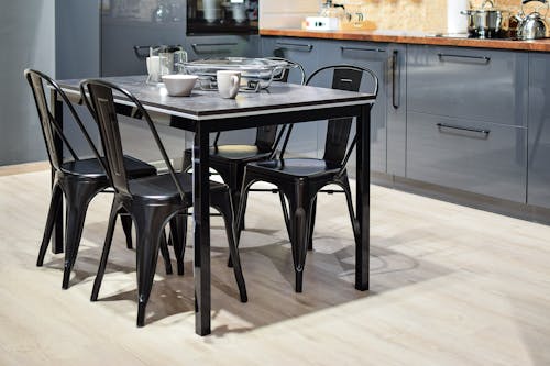 White Ceramic Mug on Black Dining Table With Four Chair Set