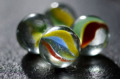 Patterned glass marbles on a dark surface — photo by ClickerHappy on Pexels