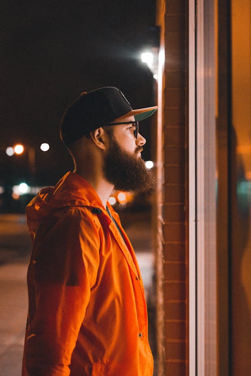 A Side View of a Man Wearing an Orange Jacket · Free Stock Photo