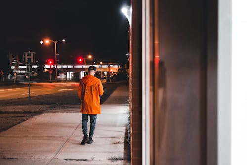 Free Back View of a Man Walking on a Street Stock Photo