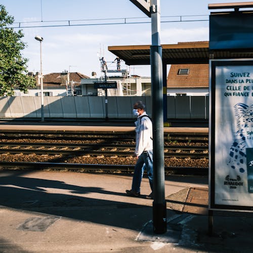 Free A Man Walking on the Train Platform Stock Photo