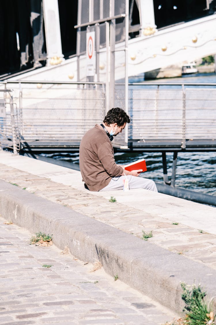 A Man Reading Book Outside