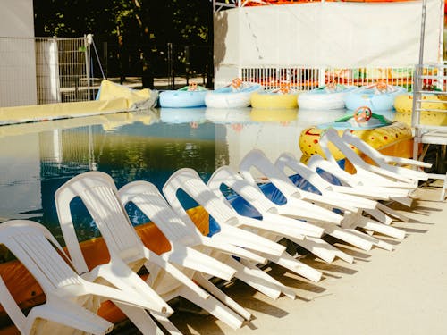 Chairs near Swimming Pool with Pontoons