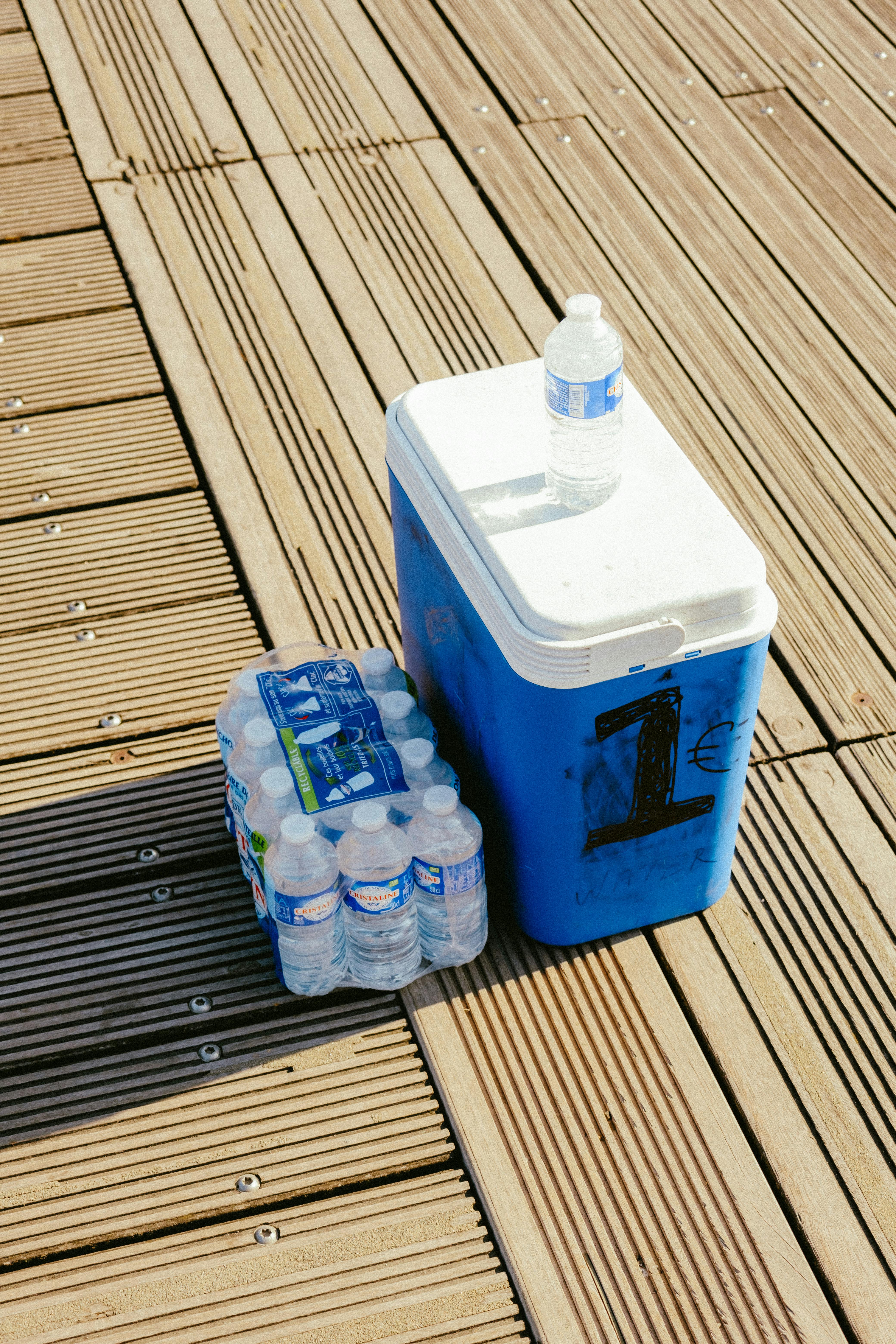 a cooler with bottled waters on the side