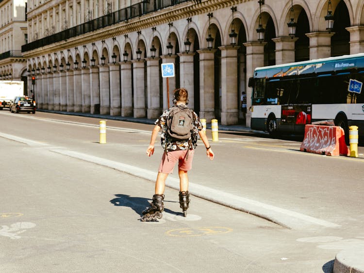 A Young Man Wearing Rollerblades On The Road