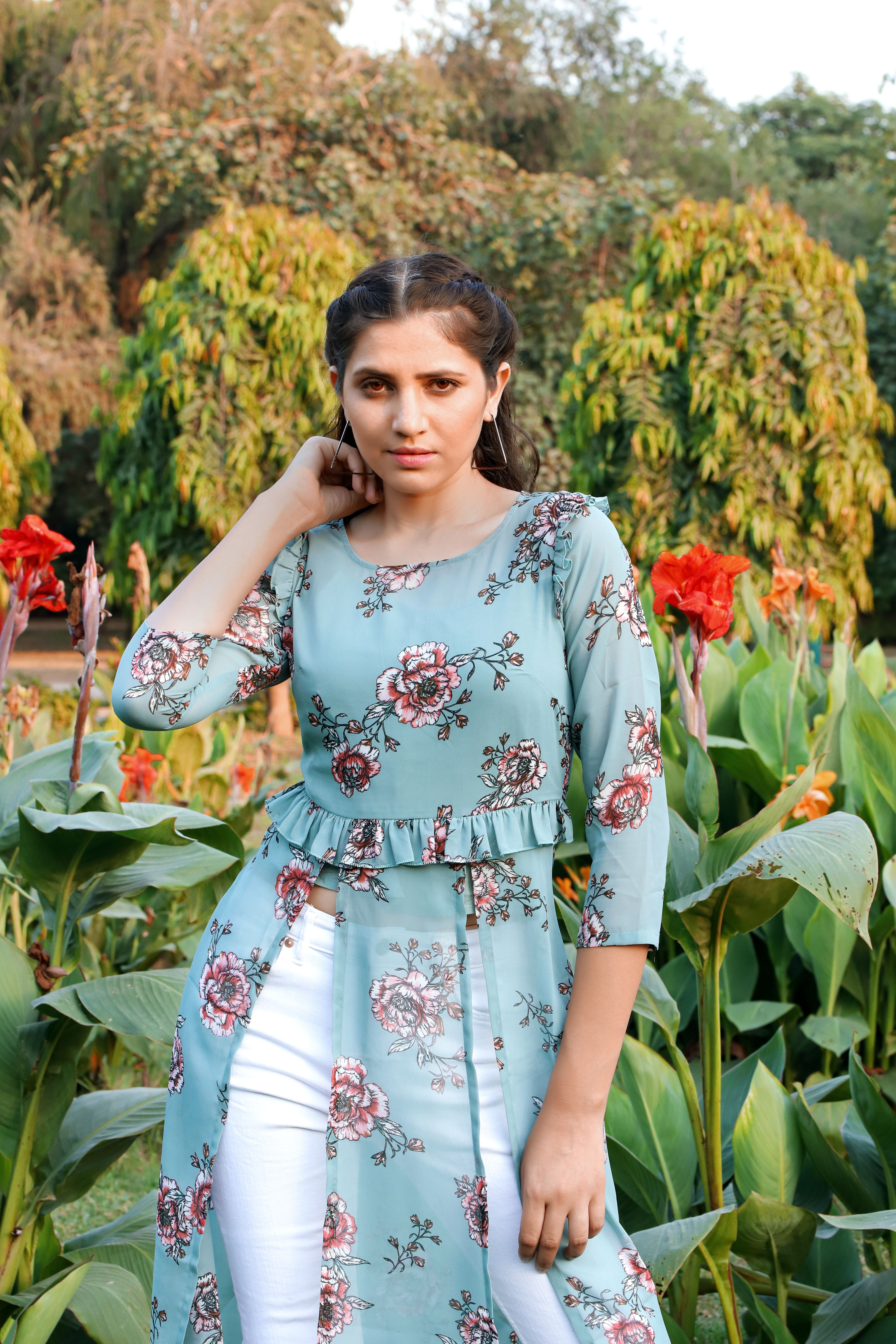 A Beautiful Woman Posing while Wearing a Floral Outfit · Free Stock Photo