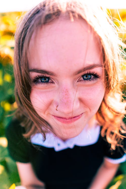 A Woman With a Nose Piercing Smiling 