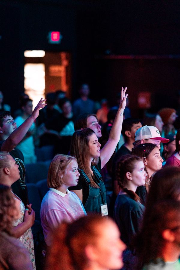 Church congregation worshipping together with raised hands