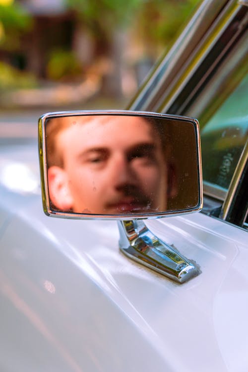 Reflection of Man's Face from the Side Mirror