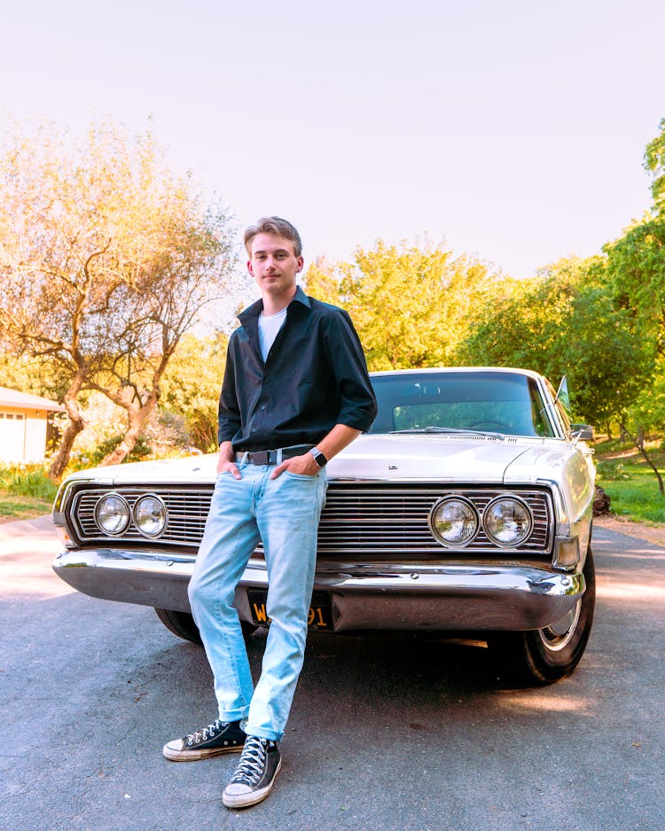 Man Leaning On A Vintage Car