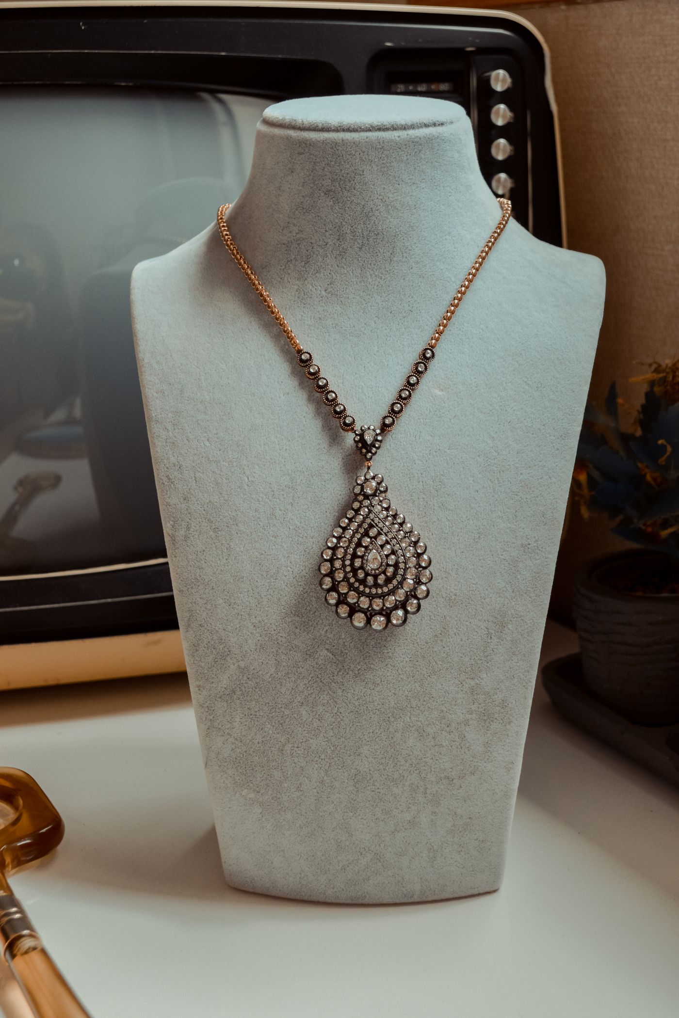 A necklace displayed on a bust in the salon