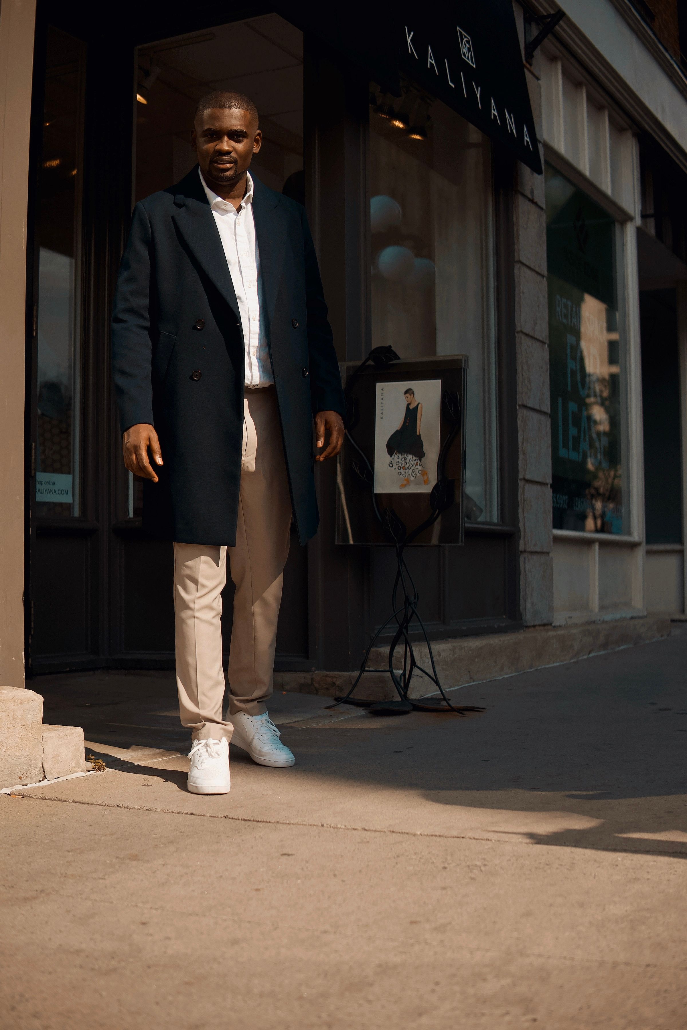 A Man Standing while Wearing a Trench Coat · Free Stock Photo